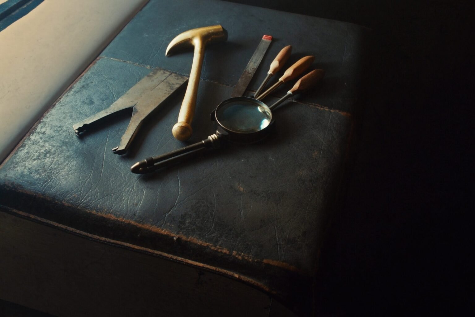 Worn jewellery making hand tools laid out on a leather bench skin